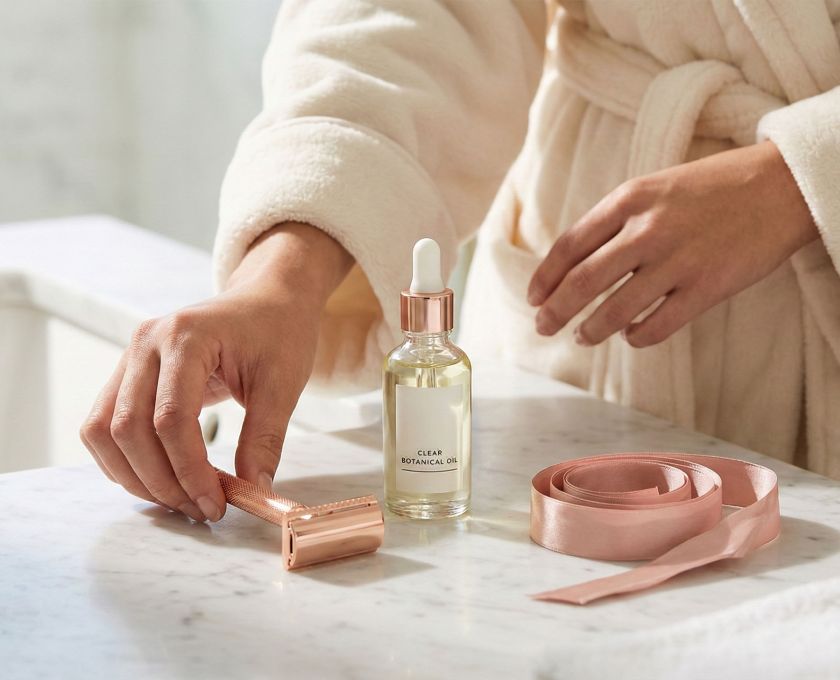 Elegant shaving tools and soothing oils for women's intimate grooming.