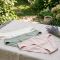 Neatly folded breathable cotton underwear in soft neutral colors on a white linen background.