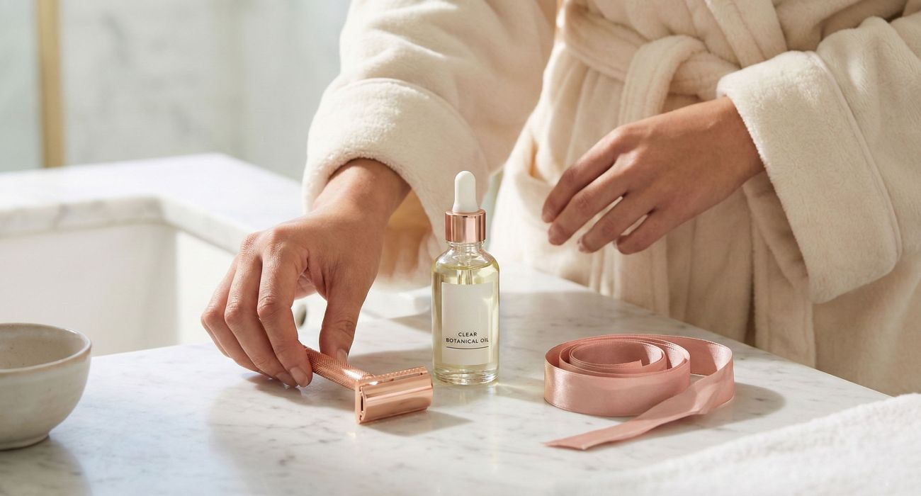 Elegant shaving tools and soothing oils for women's intimate grooming.