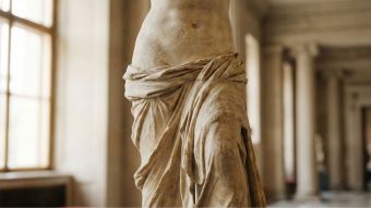 Classical marble sculpture of a woman representing historical beauty standards.