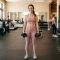 Woman holding dumbbells in gym — beginner strength training guide for women