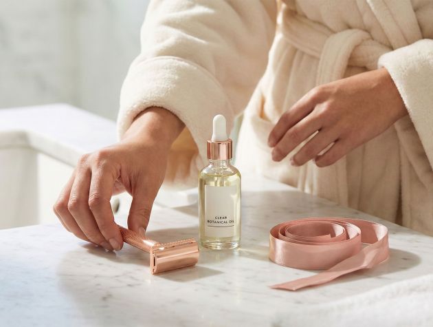 Elegant shaving tools and soothing oils for women's intimate grooming.