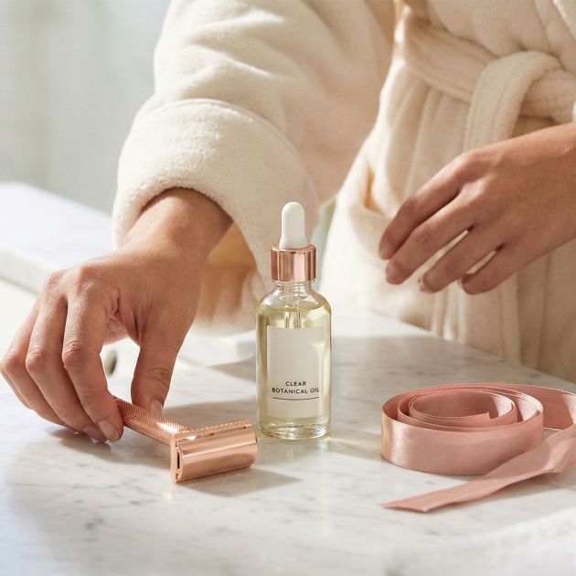 Elegant shaving tools and soothing oils for women's intimate grooming.