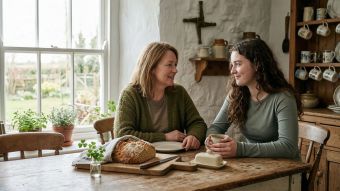 Mother and daughter celebrating Saint Patrick's Day with traditional Irish soda bread and shamrock