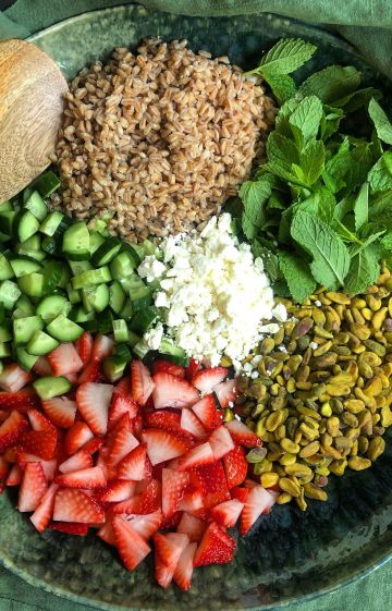 Colorful bowl of healing foods including greens, grains, and herbs for women’s nutrition